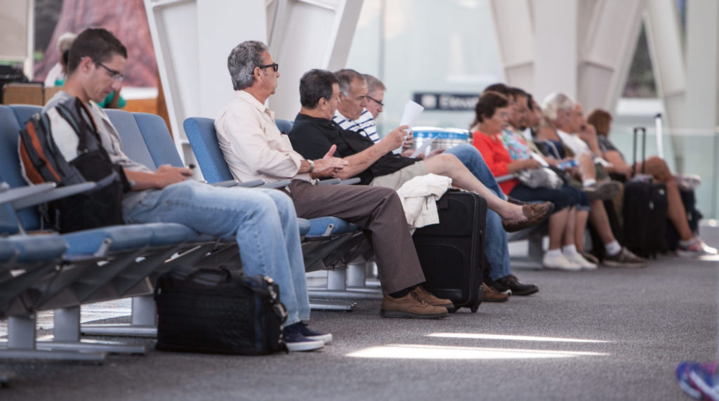 Travelers sitting in the terminal