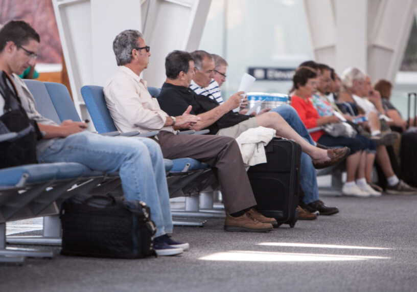 Travelers sitting in the terminal